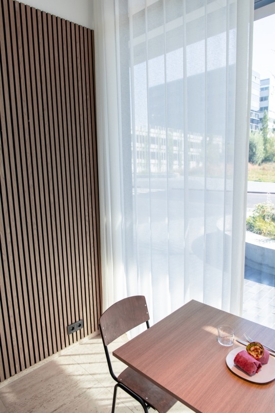chair at table with acoustic panel on the wall